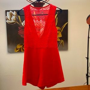 Pink low cut romper.